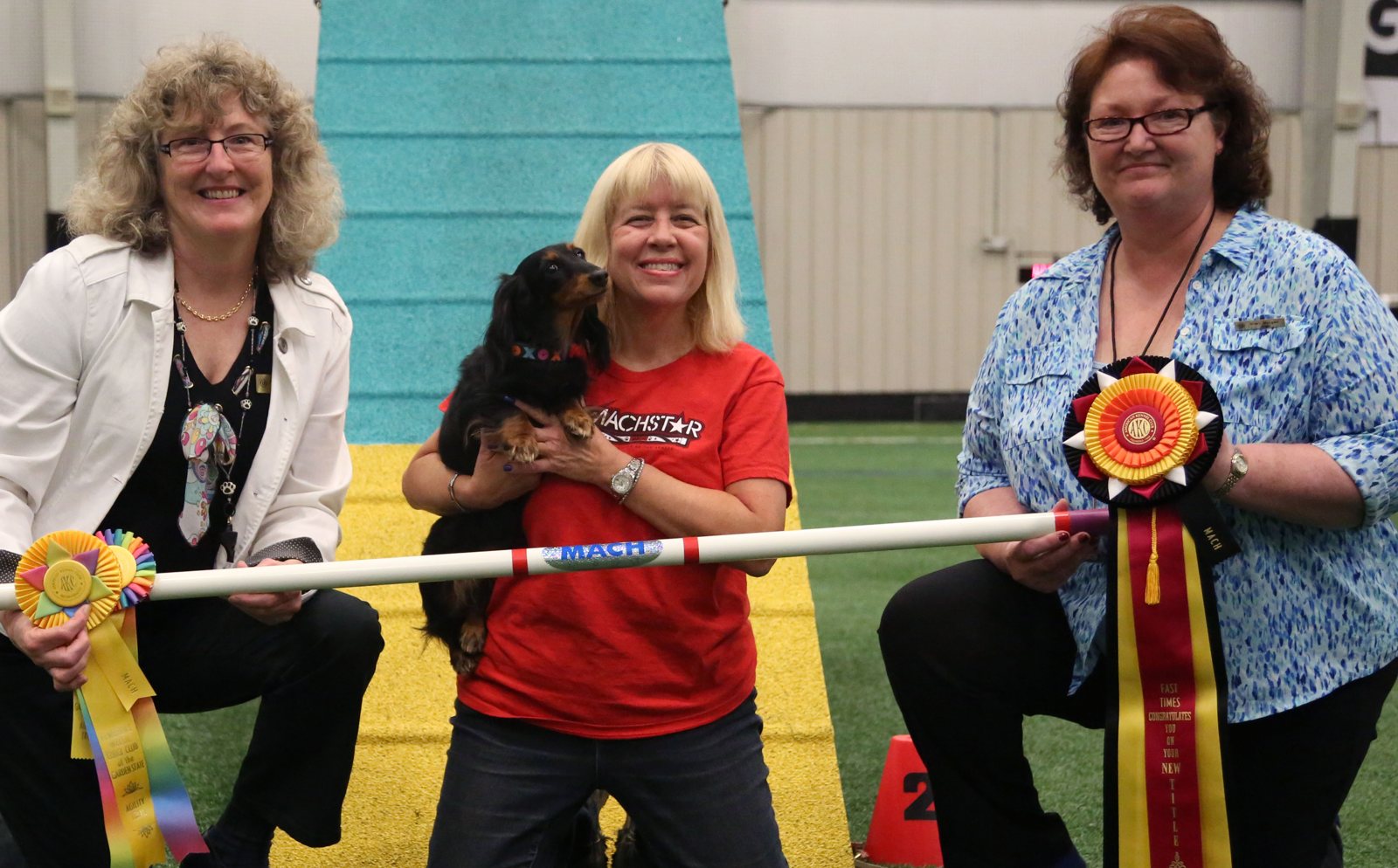 Chelsea celebrating her MACH agility championship with the judges